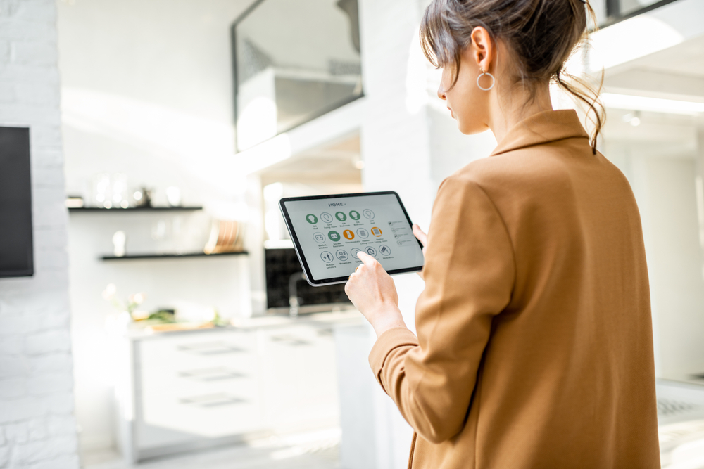 Woman using a tablet for smart home operability 